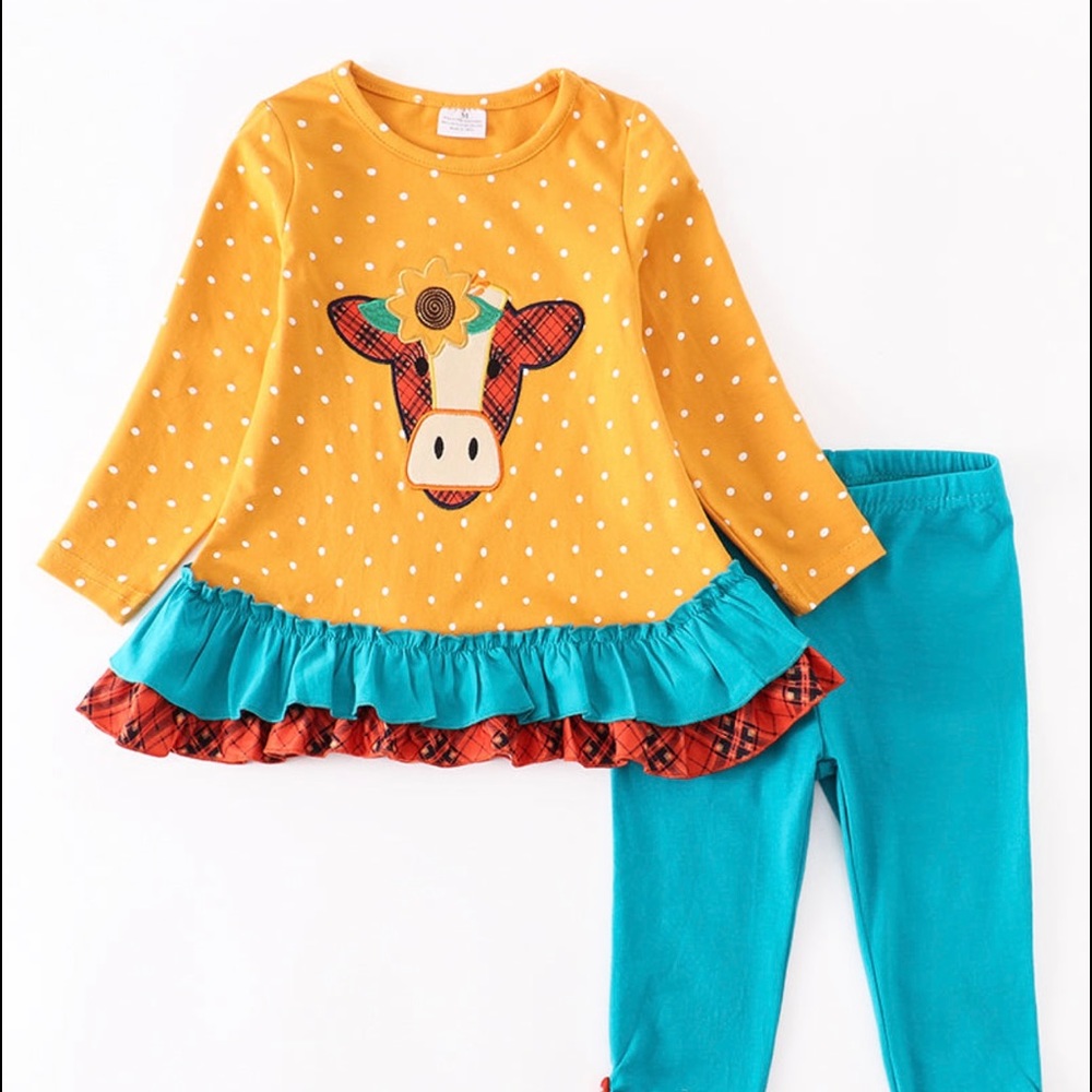 Cow appliqué outfit.